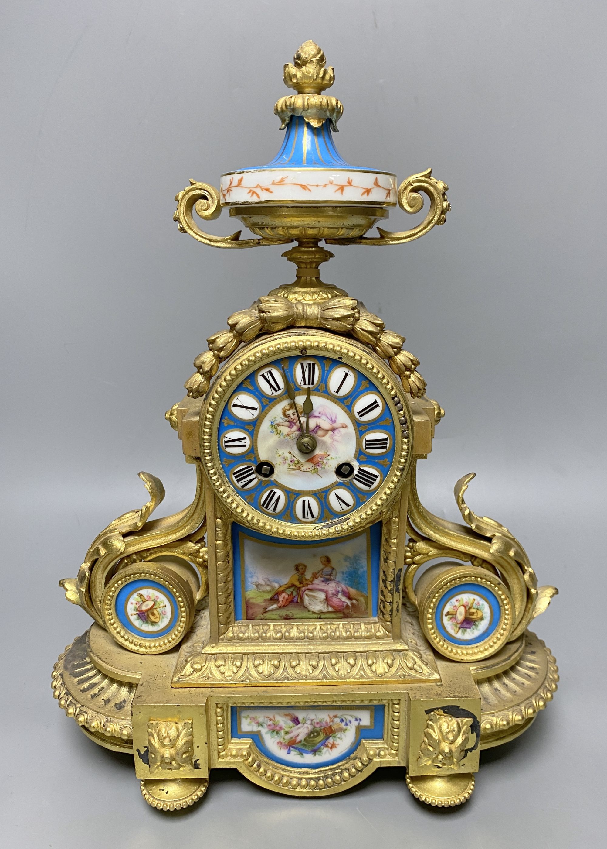 A Louis XVI ormolu mantel clock inset Sevres style panels, height 38cm